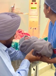 Balkaur Singh holding newborn first time